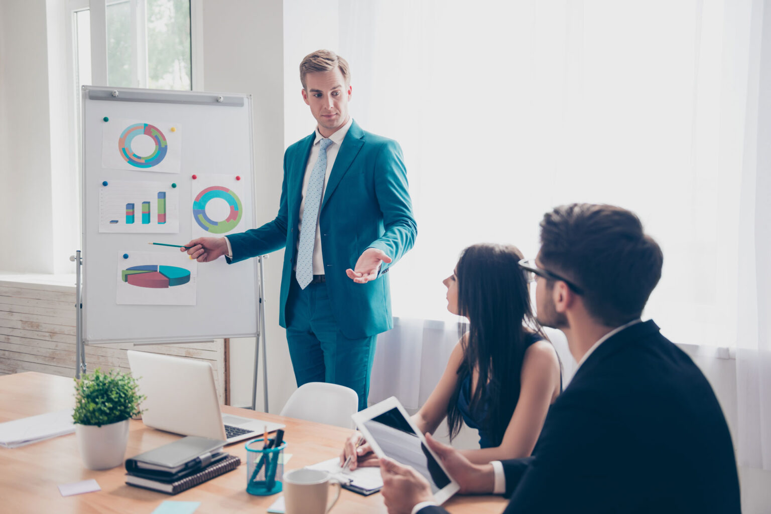 A man in a suit is giving a presentation