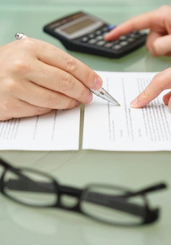 Two people are working on a paper with glasses