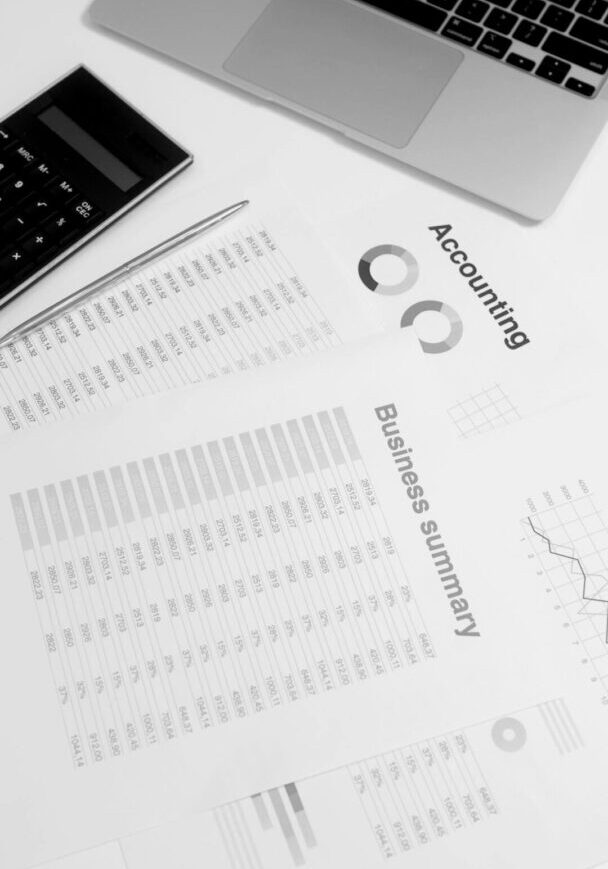 Financial documents laid out with laptop and calculator